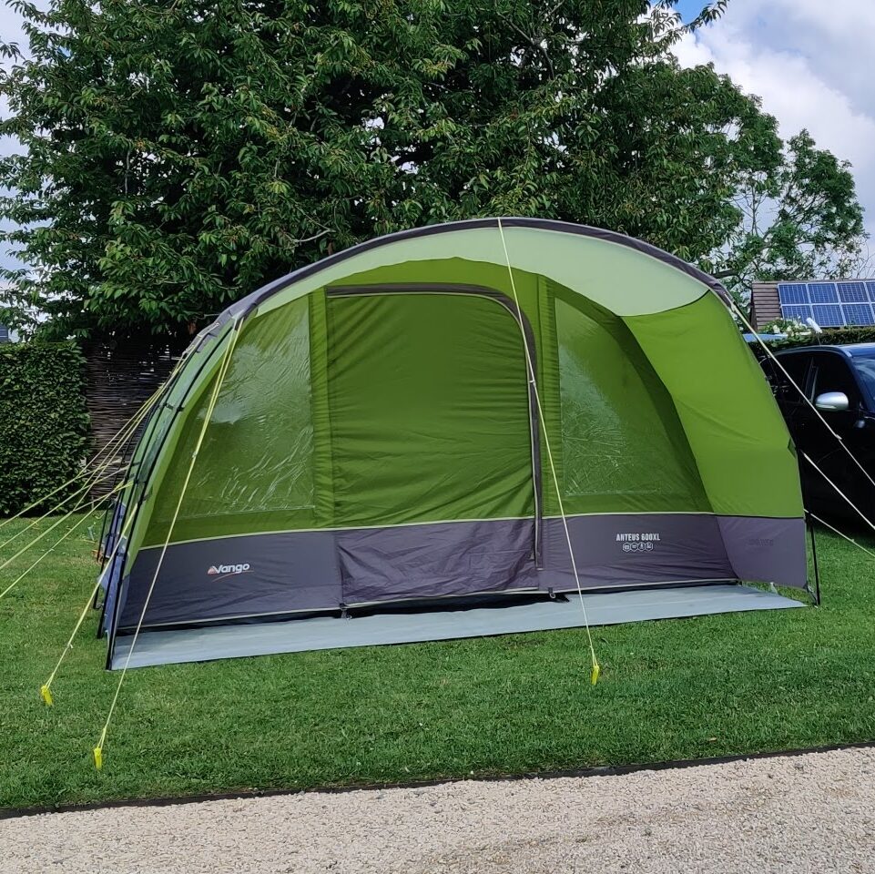 A large family Vango pole tent in green